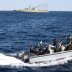 Iranian marine soldiers wave to the camera from a motor boat in the Sea of Oman during the third day of joint Iran, Russia and China naval war games in Chabahar port, at the Sea of Oman, Iran, December 29, 2019. Mohsen Ataei/Fars news agency/WANA (West As